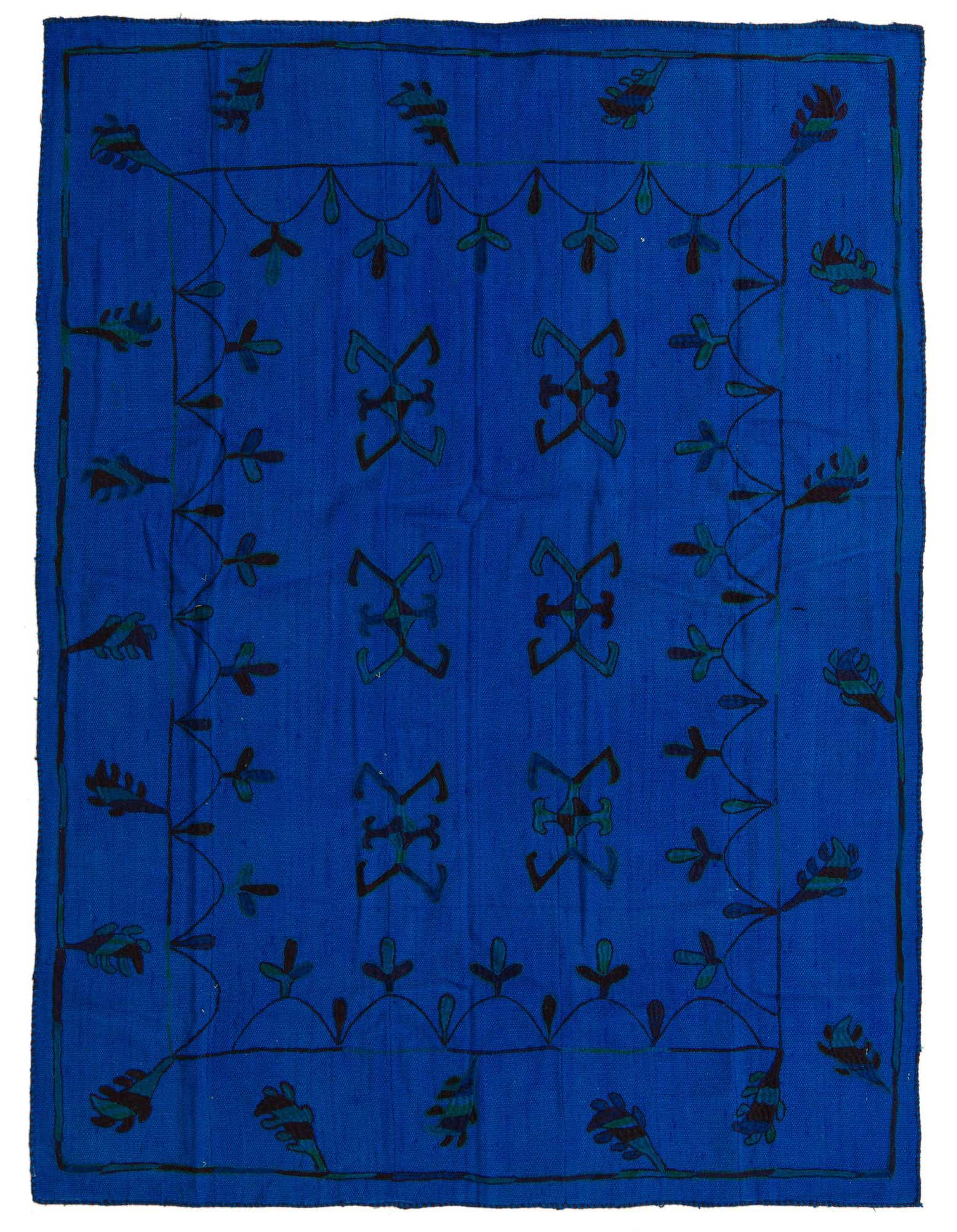 A 5' 3 x 6' 8 square Kilim Suzani rug featuring a vibrant blue background with tribal and abstract patterns in browns and tans.