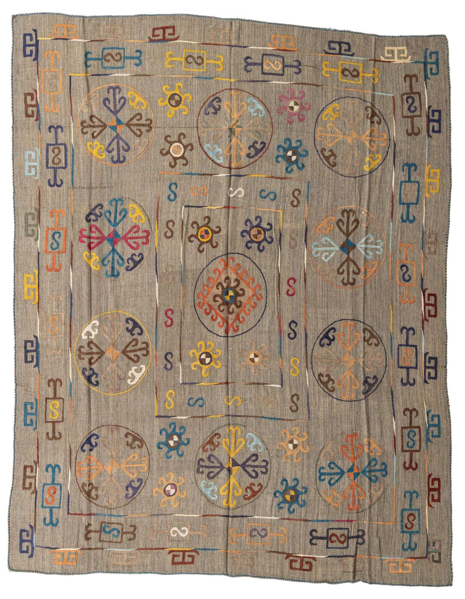 A square 8' 7 x 9' 6 Kilim Suzani rug with a brown base and colorful tribal and abstract motifs.