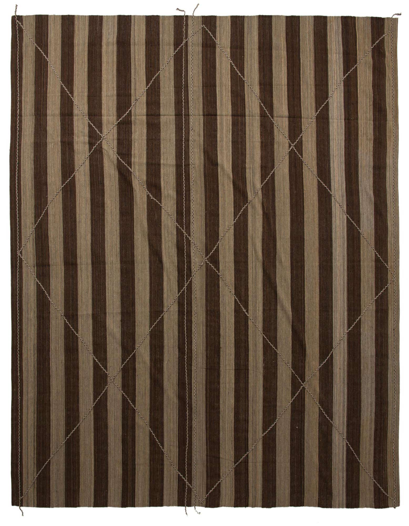 A large square brown and tan striped wool shag rug with subtle tribal diamond patterns, suitable for a living room.