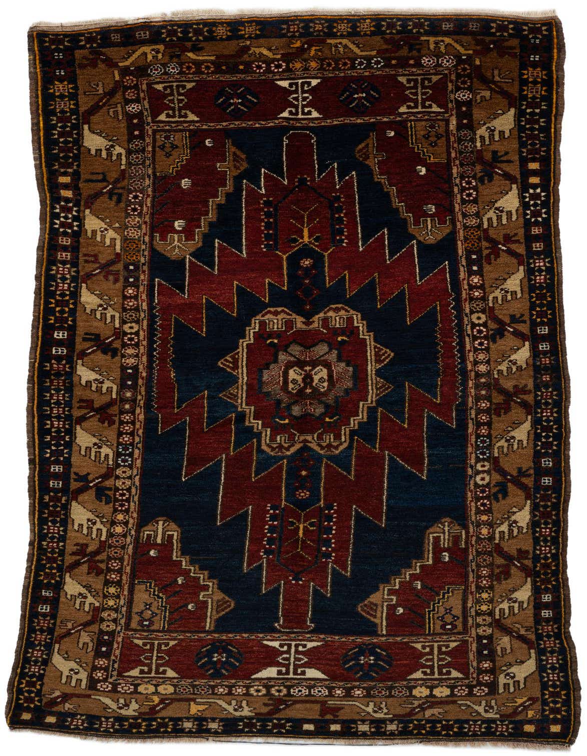 A 5x8 rectangular Anatolian rug featuring a traditional medallion pattern in deep reds, navy blue, and tan, with intricate borders.