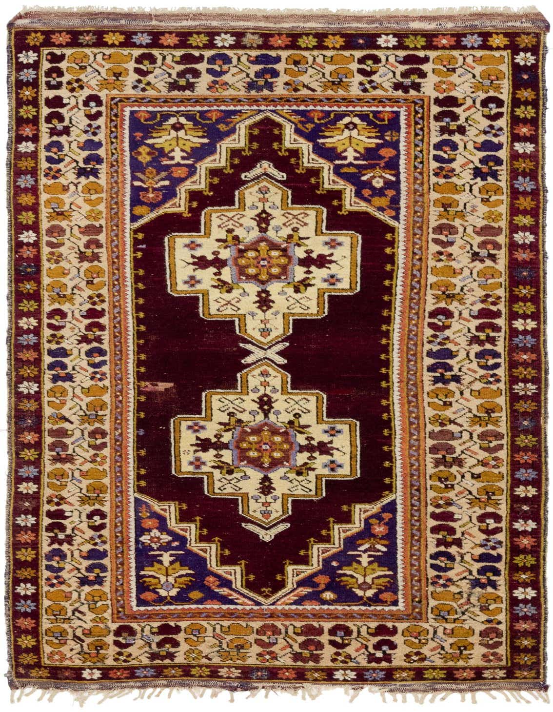 A 4x6 rectangular Anatolian rug featuring a deep red field with cream, blue, and yellow traditional medallion and tribal patterns.