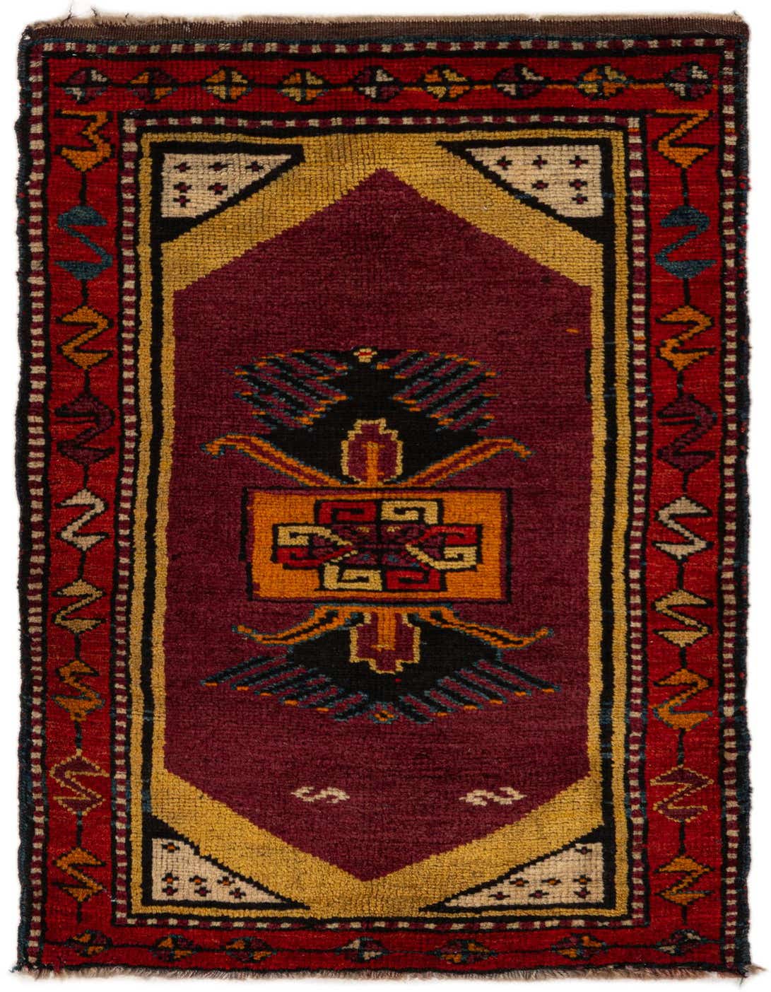 A 2x3 rectangular Anatolian wool rug featuring a central medallion in gold, black, and orange on a deep red field, with a red border.