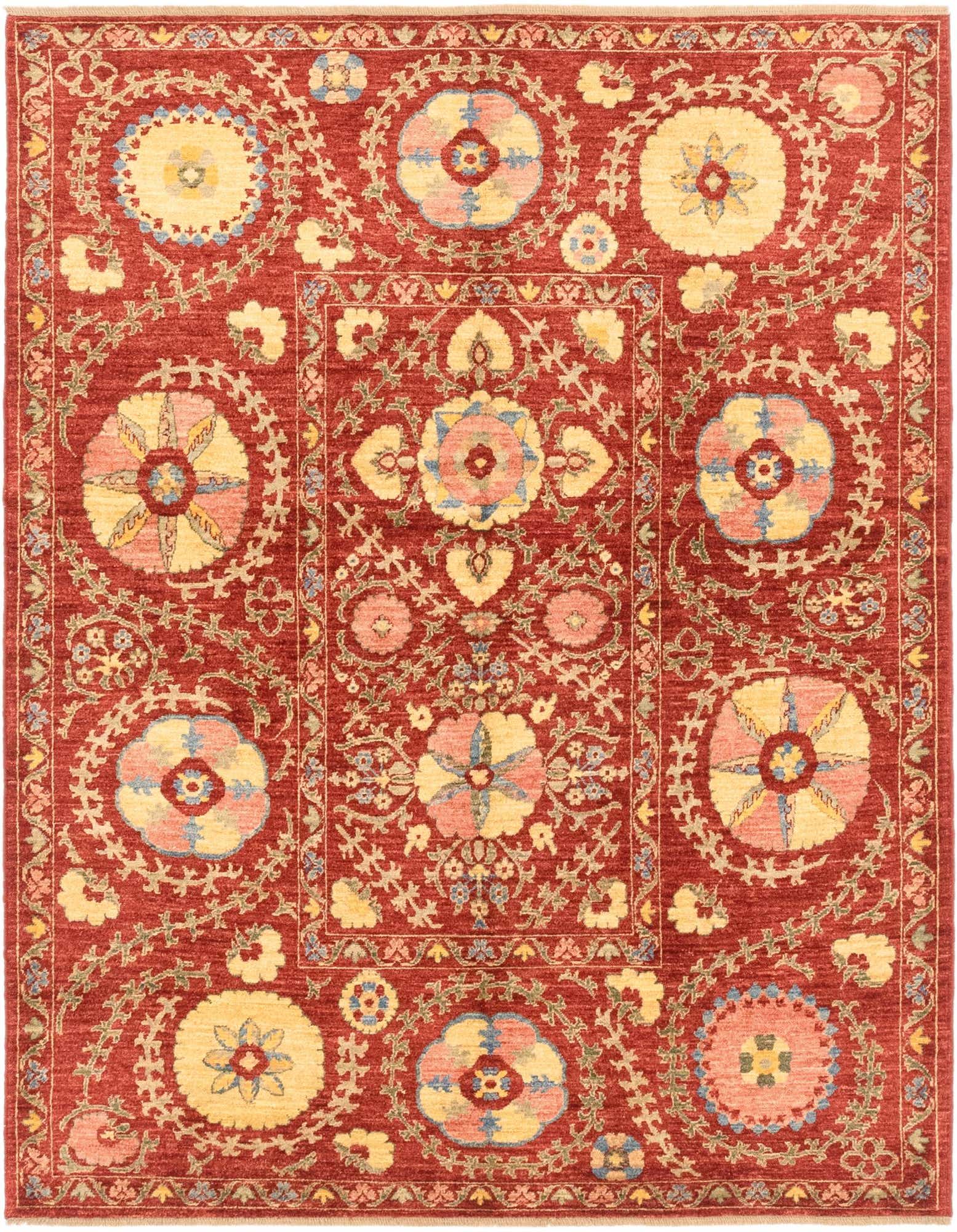 A 5x7 rectangular Ariana Ziegler rug featuring a traditional tribal pattern with large floral medallions in yellow, pink, and blue on a rich red background.