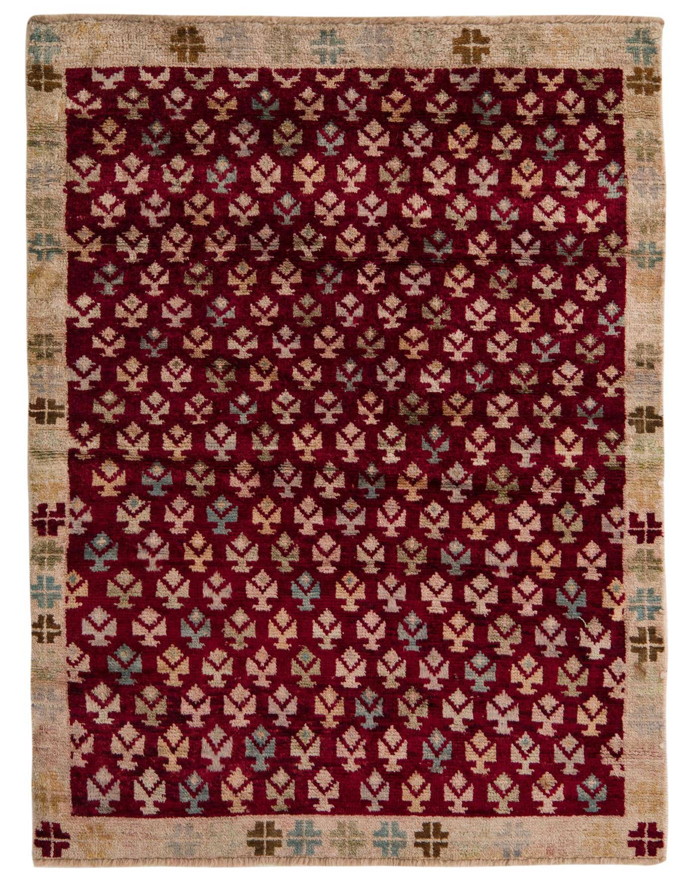 A 4x6 rectangular Balouch rug with a deep red field and repeating tribal motifs in cream and light blue, framed by a light beige border with cross patterns.
