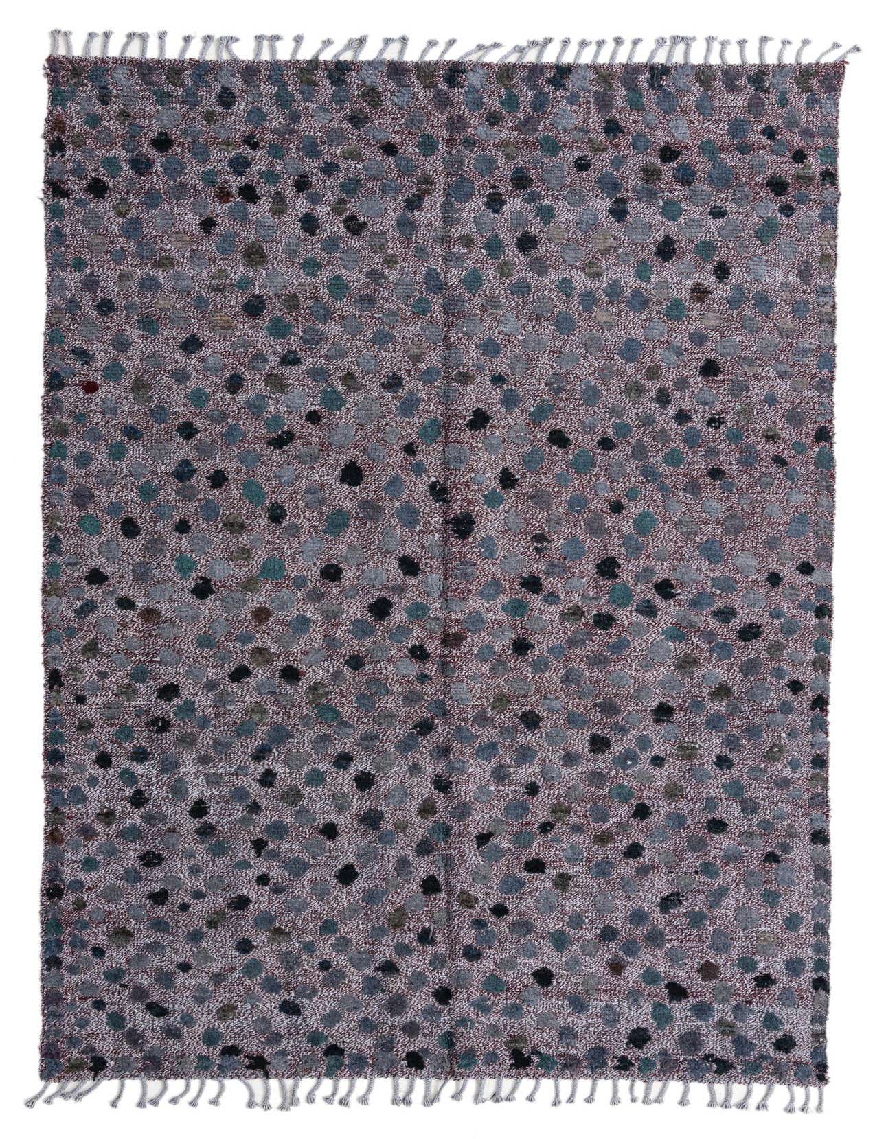 A 5x8 rectangular Darya rug with a modern abstract pattern in various shades of red, gray, and black, featuring a textured wool pile and fringed edges.