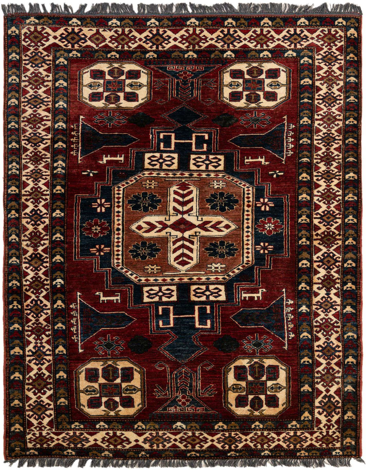 A 5x7 rectangular Kazak rug with a rich red field, featuring a large central medallion and geometric patterns in navy, cream, and brown, with fringed ends.