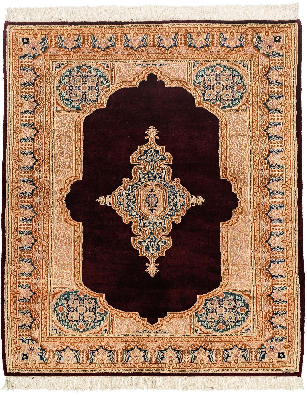 A 4x6 rectangular Kerman rug featuring a deep red field with an elaborate gold and blue medallion, surrounded by a detailed border.