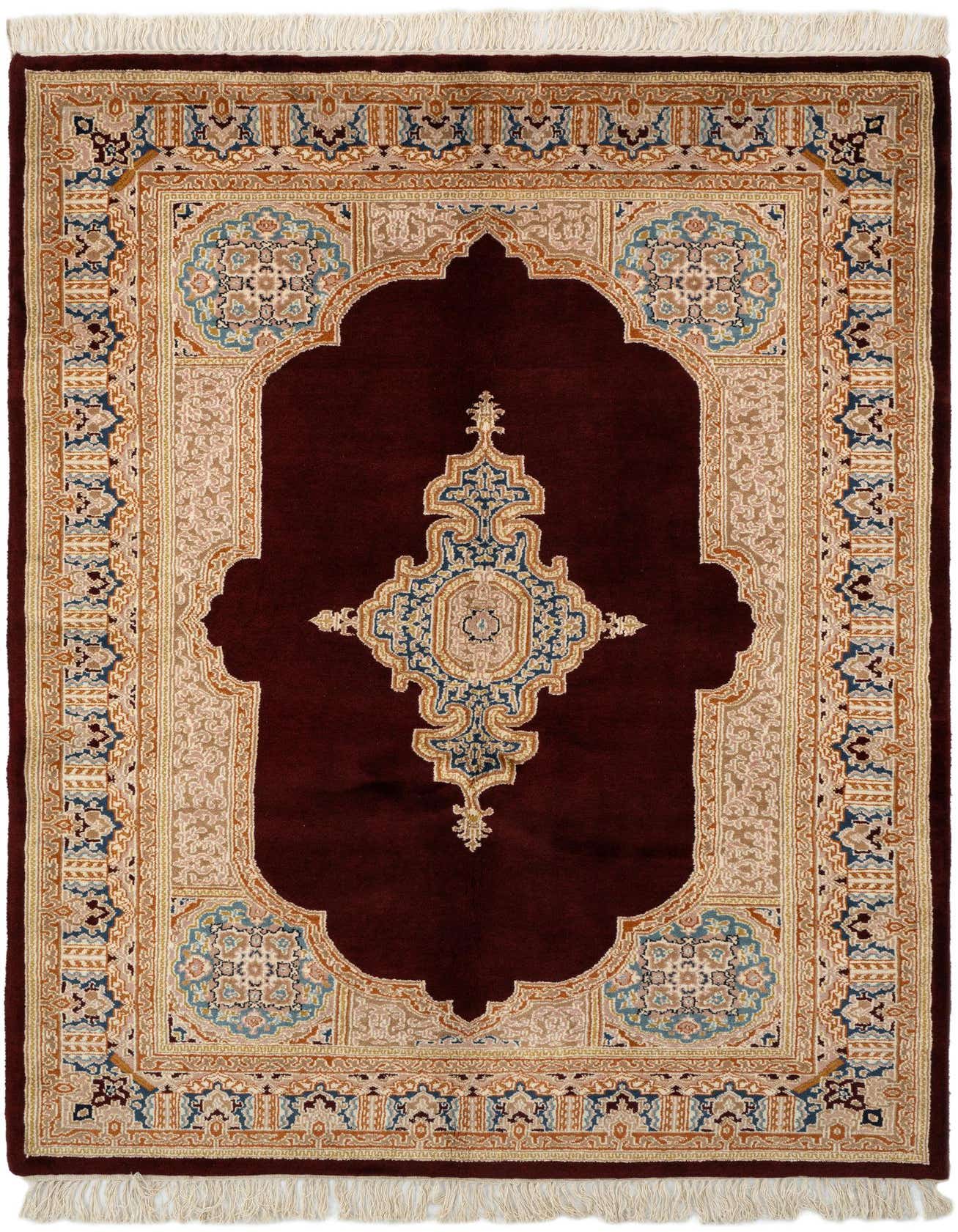 A 4x6 rectangular Kerman wool rug featuring a rich red field with a detailed traditional medallion and ornate border in blue, beige, and gold.