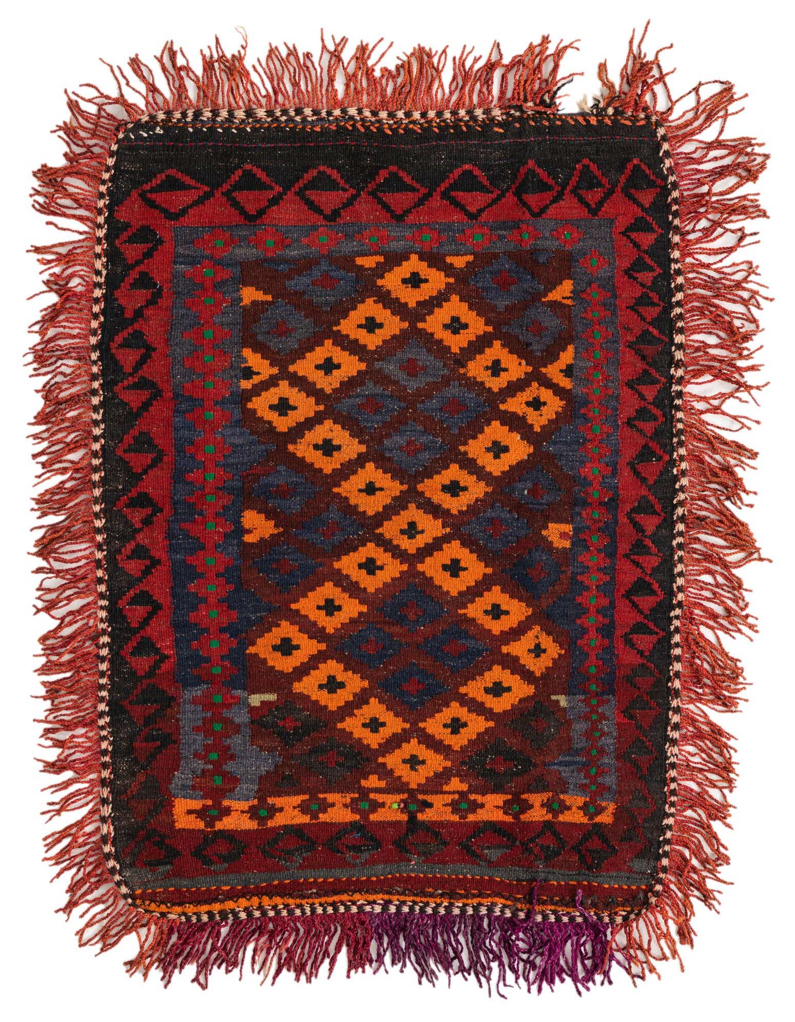 A 3x4 rectangular tribal flatweave rug featuring a central pattern of orange and blue diamonds, bordered by intricate red, black, and green designs, with red fringed edges.