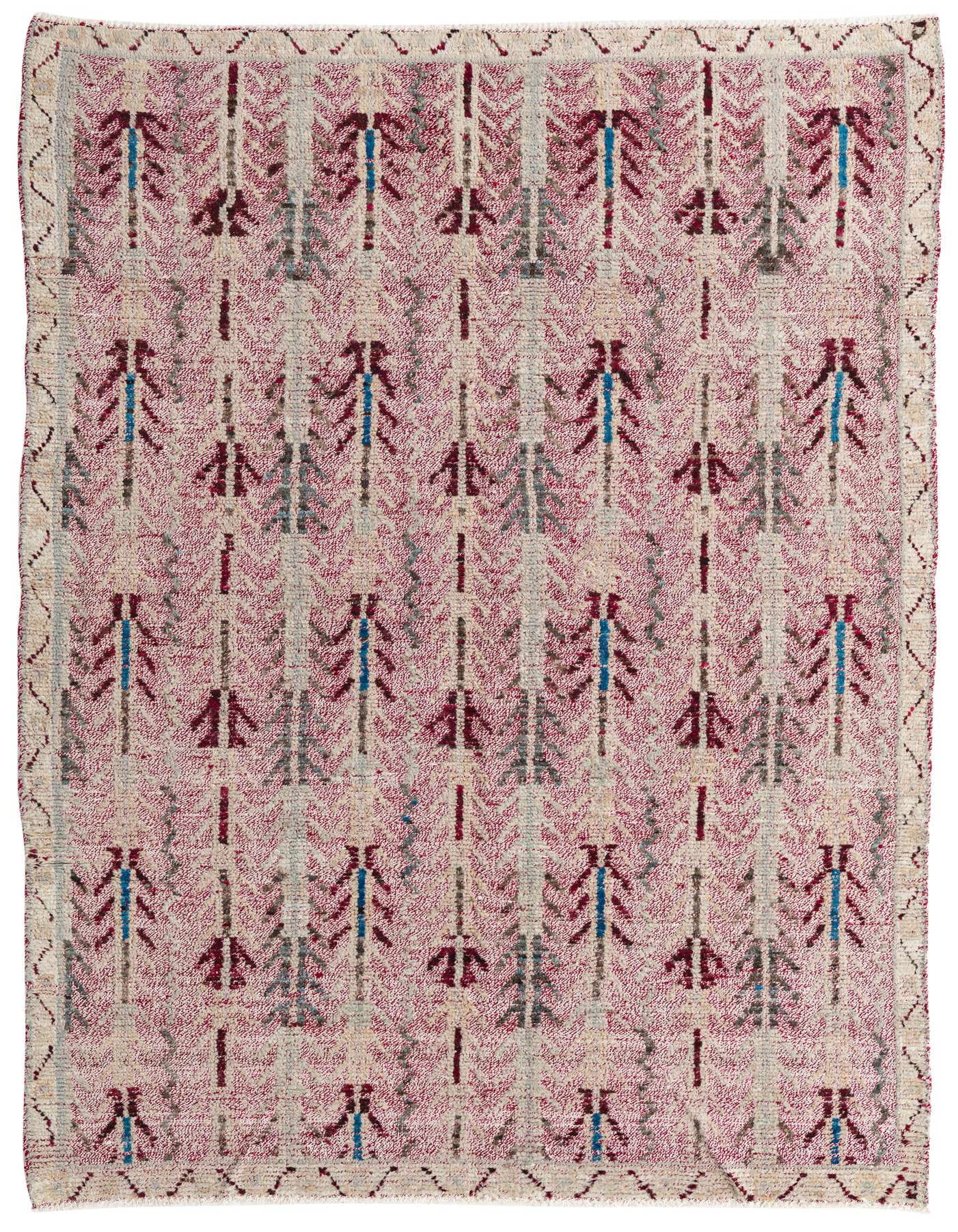 A 6x9 rectangular wool rug featuring a Southwestern abstract pattern in shades of red, cream, and blue.