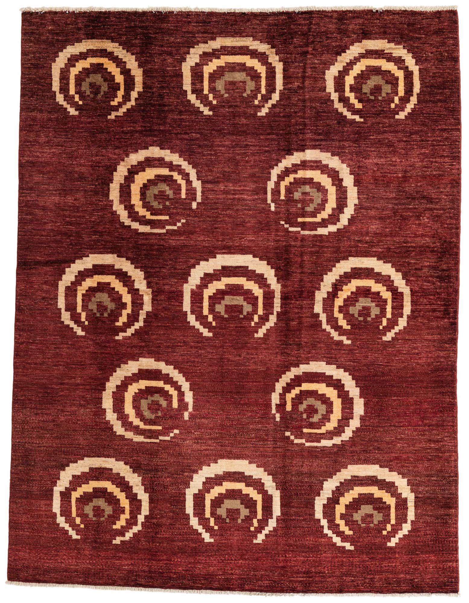 A 6x9 rectangular Modern Ziegler rug featuring a deep red background with abstract, concentric circle patterns in beige and gold.