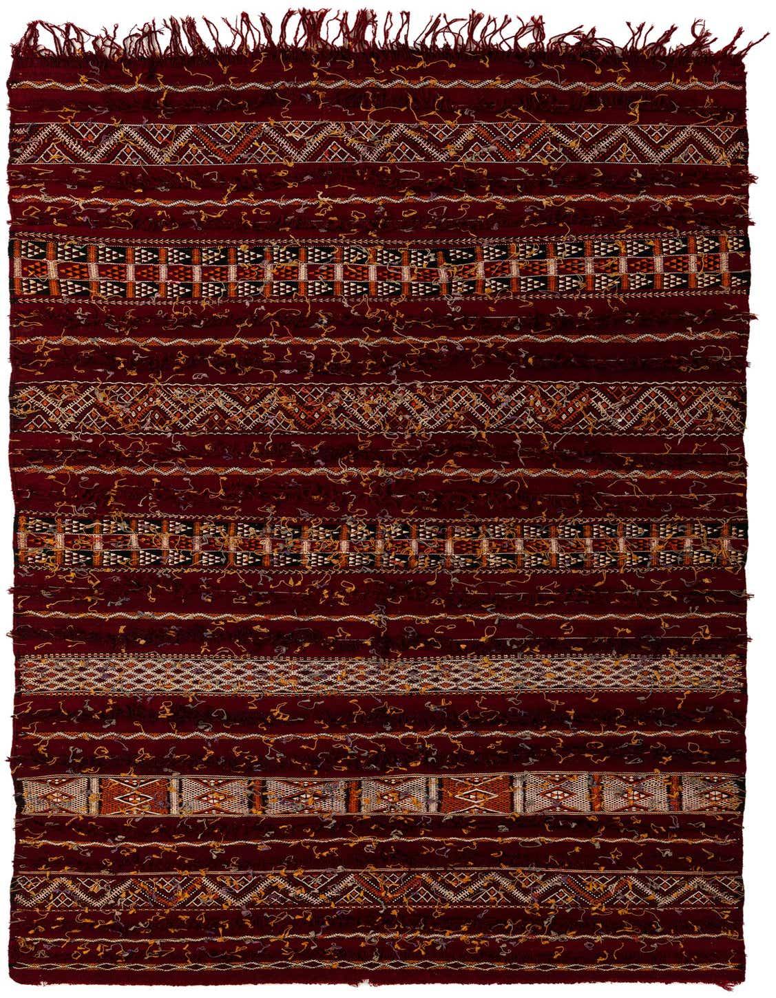 A 6x9 rectangular red wool shag rug with Southwestern and tribal patterns, featuring stripes of white, orange, and black geometric designs.
