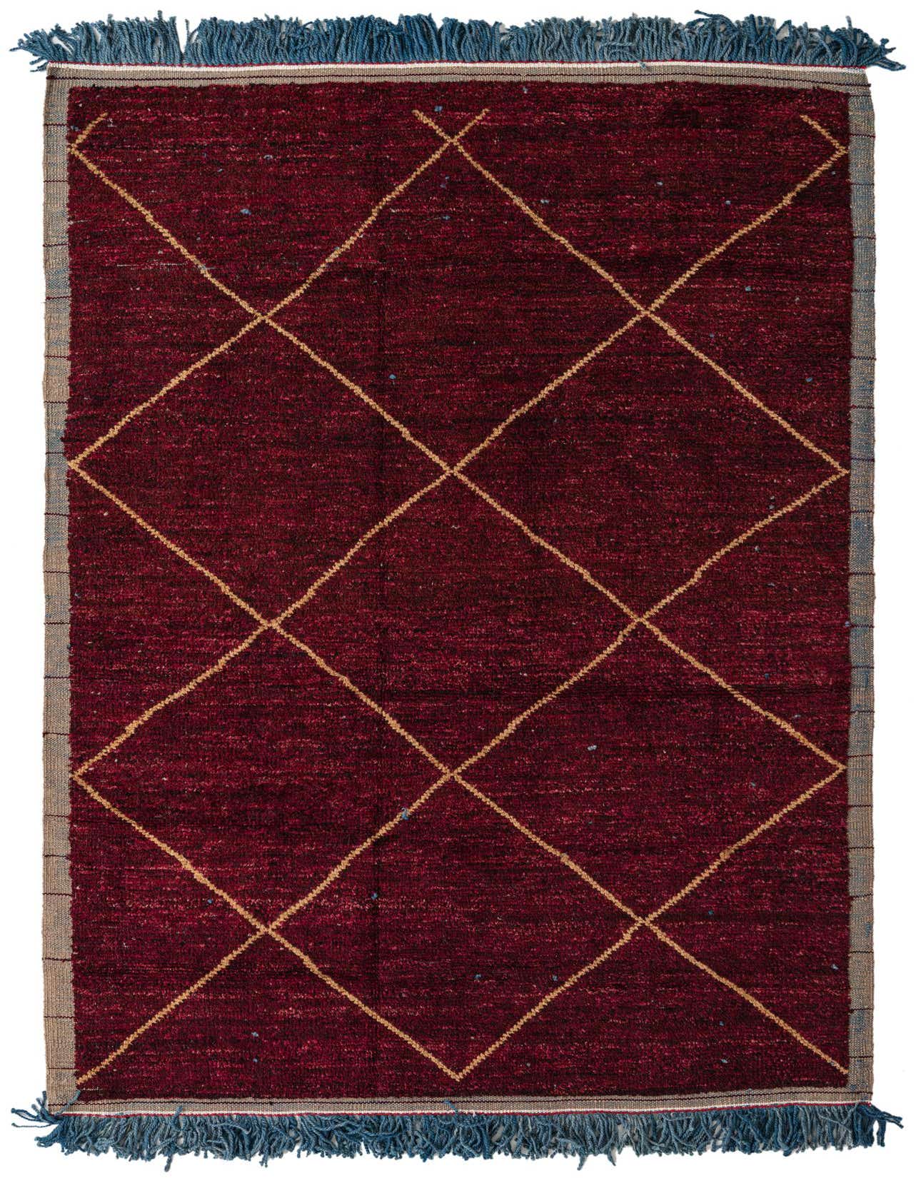 A 6x9 rectangular red wool shag rug with a modern tribal diamond pattern and blue fringe.