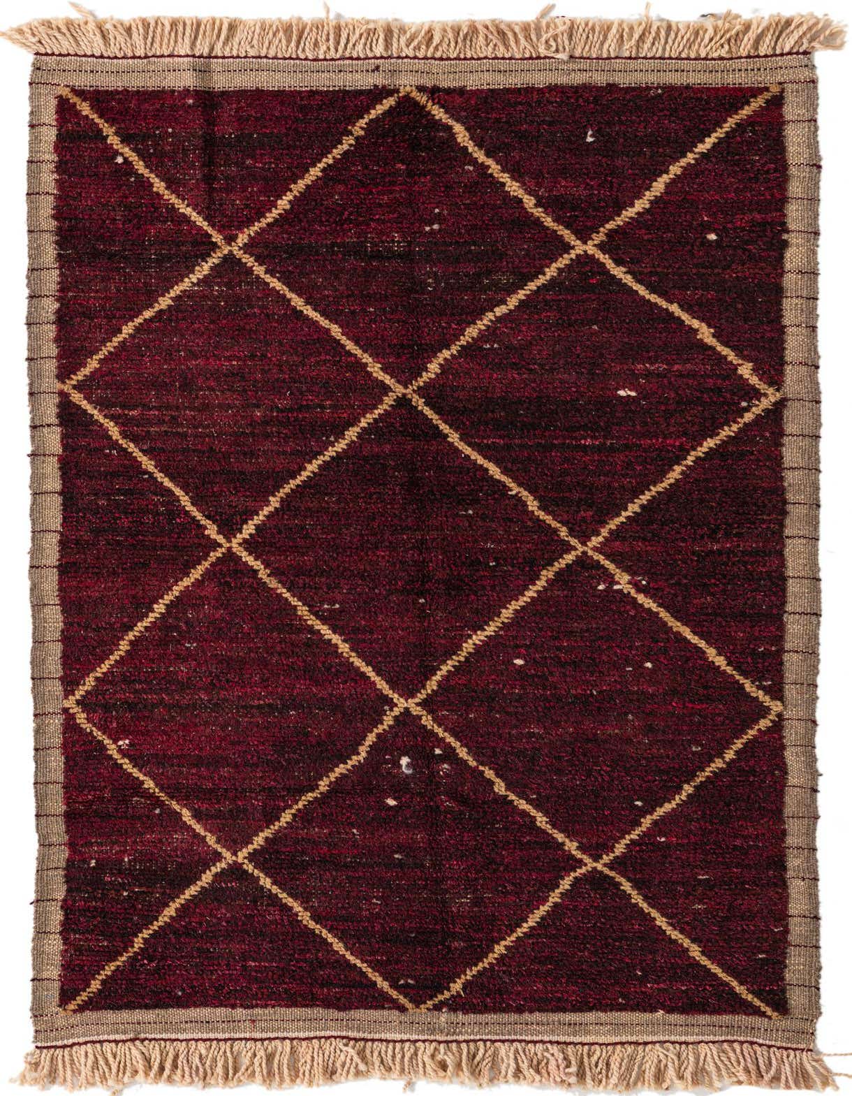 A 4x6 rectangular red wool shag rug with a cream diamond tribal pattern and fringed ends, suitable for a living room.