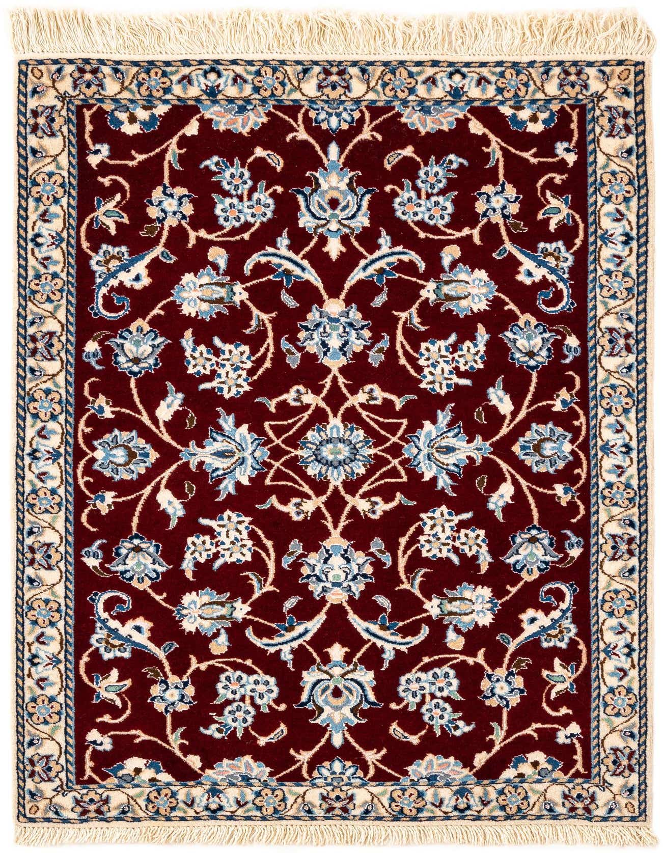 A rectangular handmade Persian rug with a deep red field and intricate blue, cream, and gold floral patterns, bordered by cream and blue motifs.