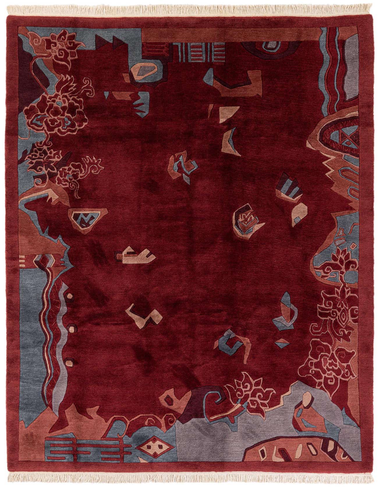 A 7x10 rectangular Rugs.com Tibet rug featuring a deep red field with abstract modern oriental patterns in blue, grey, and brown tones.