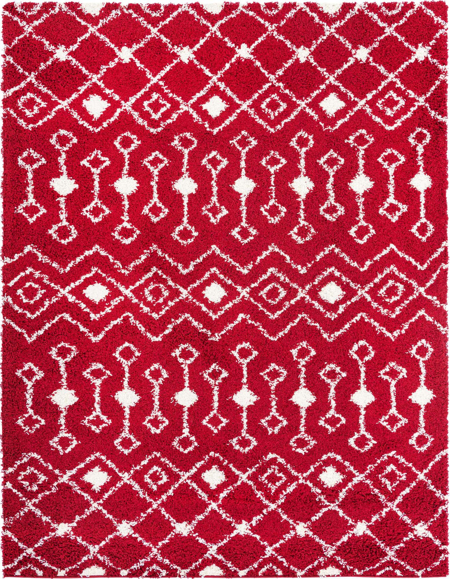 A vibrant 8x10 red rectangular shag rug with a white tribal geometric pattern, featuring diamond and zigzag motifs.