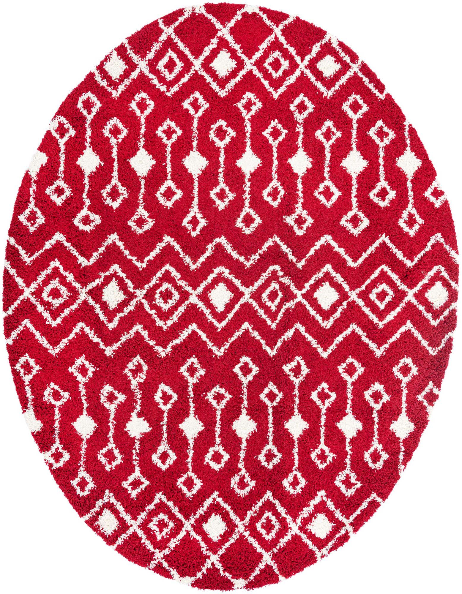 A round red shag rug with a white modern tribal pattern of diamonds and zigzags, featuring a textured pile.