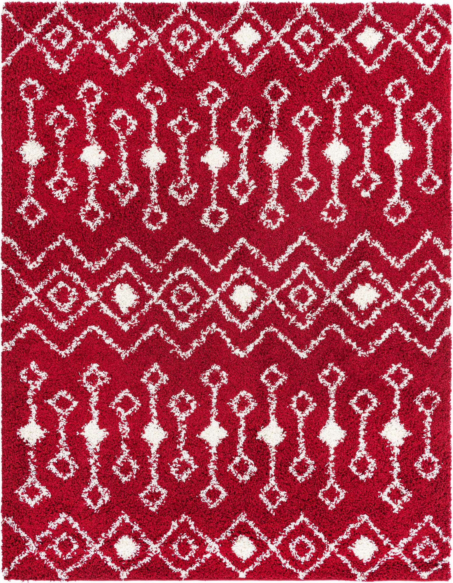 A vibrant red 7' 10 x 7' 10 square shag rug with a white tribal geometric pattern, featuring diamonds and zigzag lines, perfect for a modern living room.