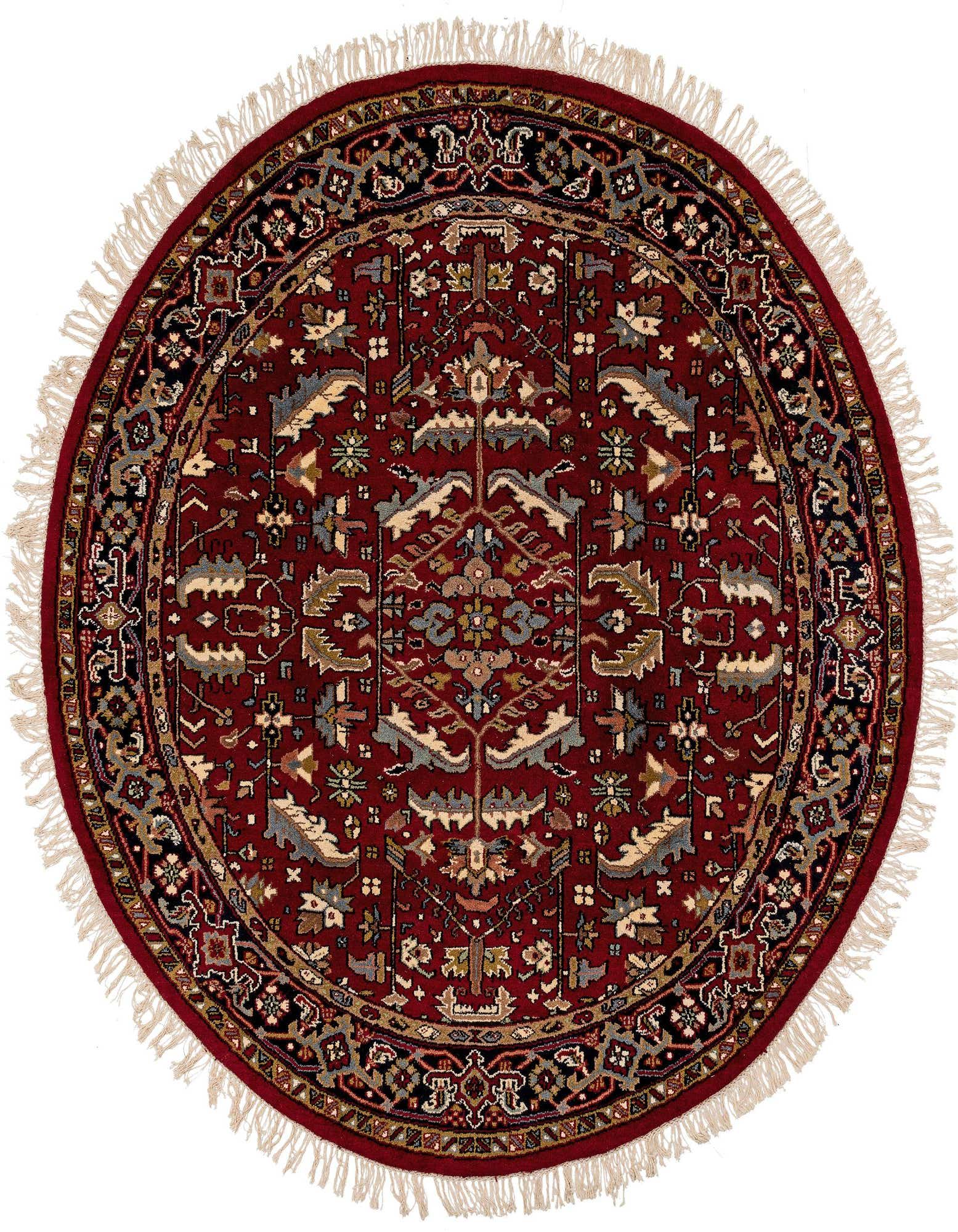 A 7' 2 round red Heriz wool rug with a traditional Oriental medallion pattern and fringe.