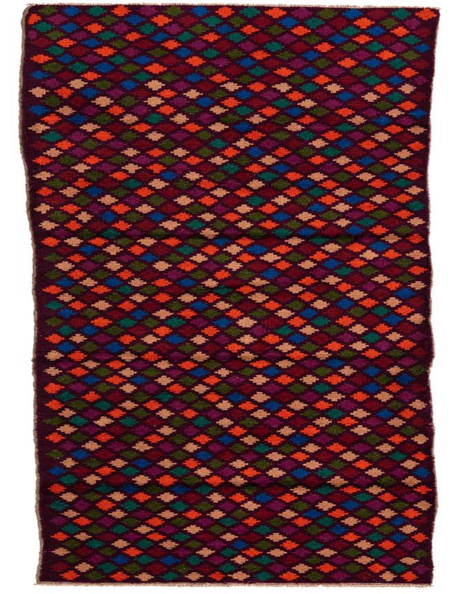 A 9 ft Balouch runner rug with a traditional tribal pattern of colorful diamonds in reds, blues, greens, and oranges on a dark red background.