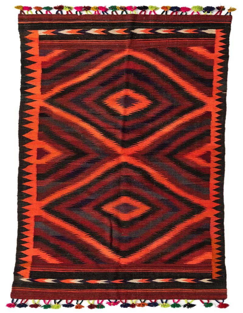 A 10 ft Kilim Fars runner rug in red, black, and orange with a tribal geometric diamond pattern and colorful tassels.