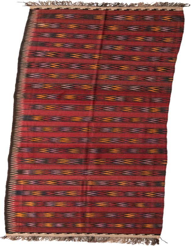 A long, red Kilim Fars runner rug with tribal stripes in orange, purple, and black, featuring fringed ends.