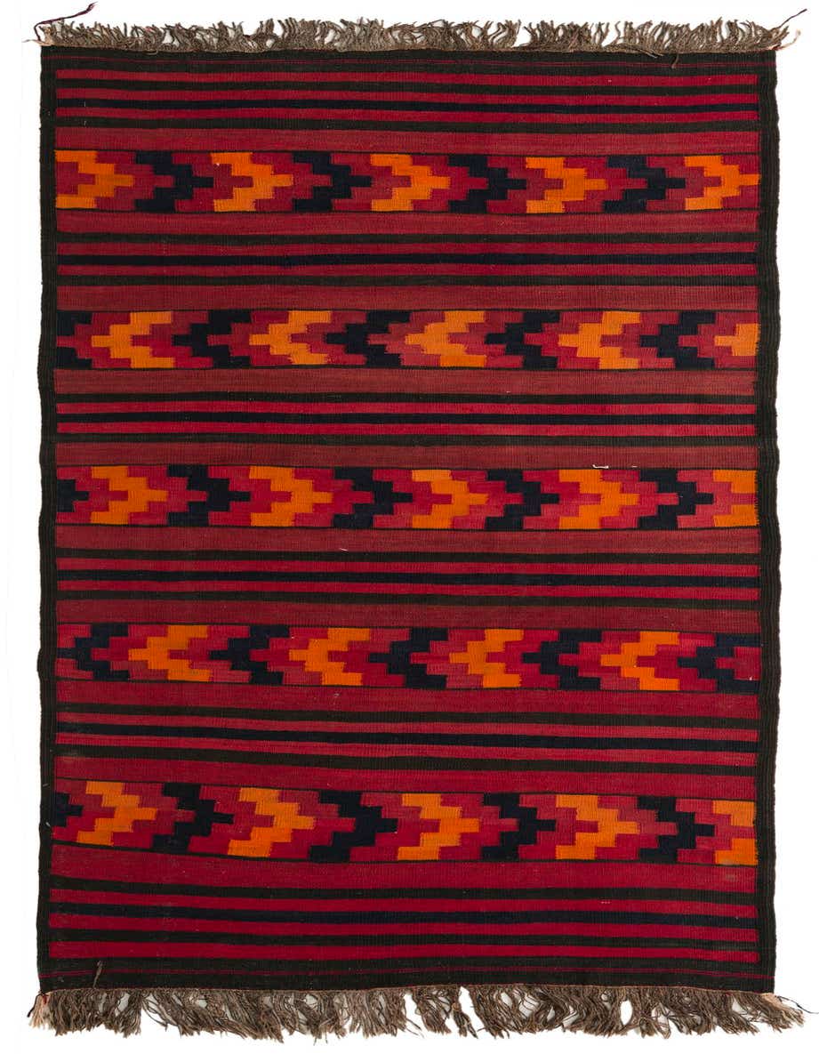 A 9 ft Kilim Fars runner rug with a tribal pattern in shades of red, orange, and black, featuring fringes.