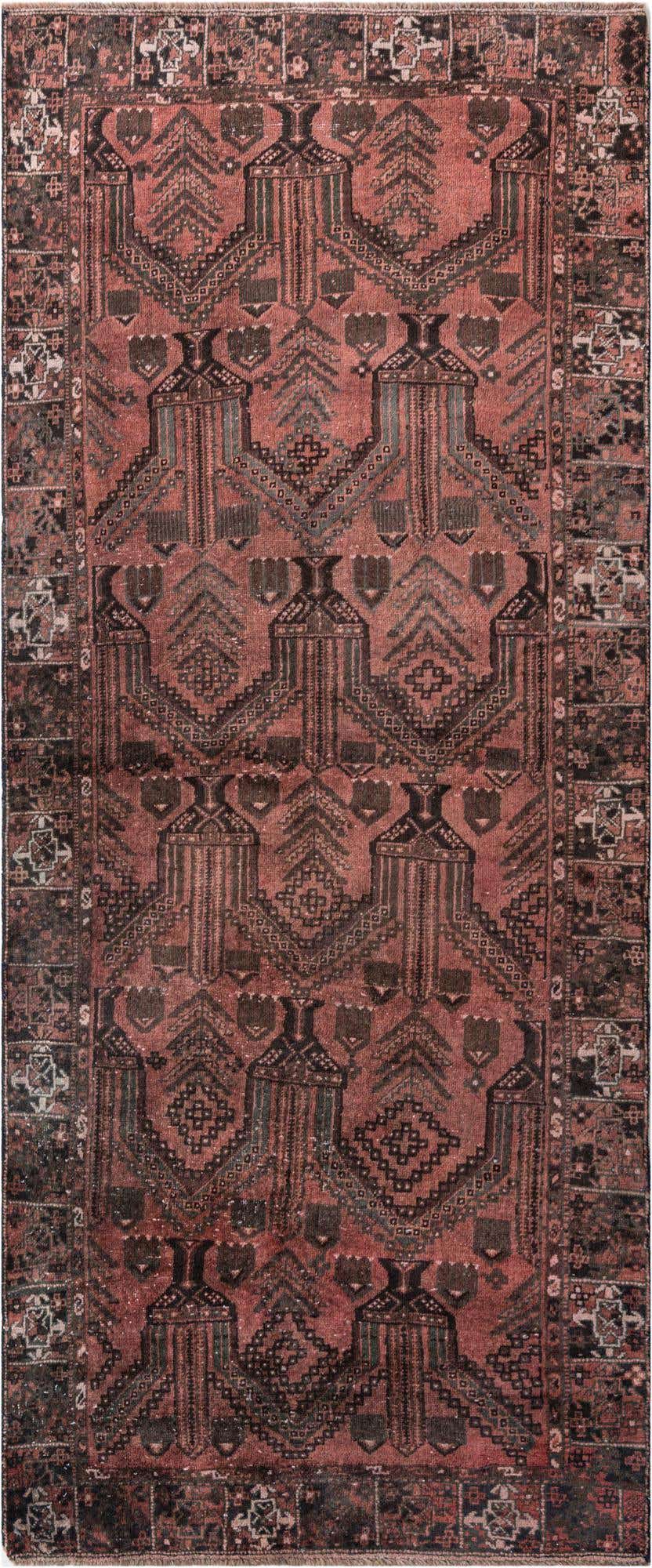 A 9 ft runner rug in shades of red and black with a distressed Persian geometric pattern, ideal for a hallway.