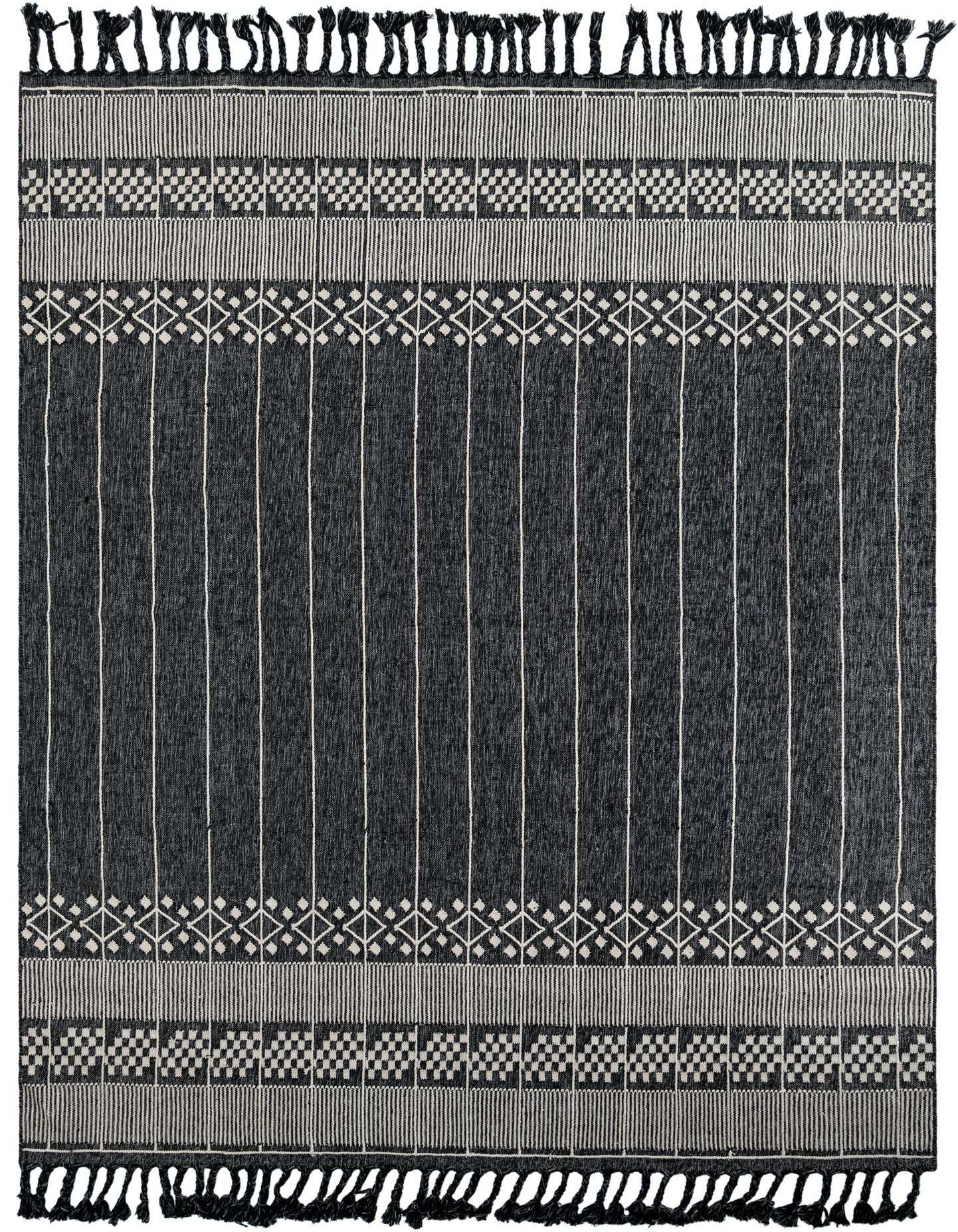 A 9x12 rectangular black and white bohemian rug with vertical stripes and geometric patterns, featuring decorative tassels.