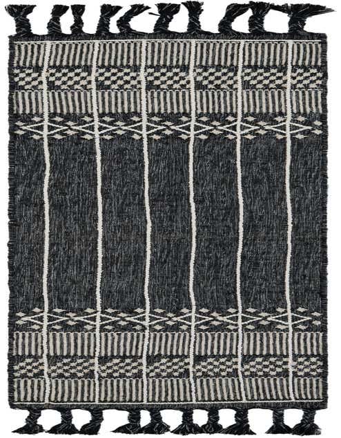 A black and off-white Eco Bohemian runner rug with stripes and geometric patterns, featuring braided tassels.