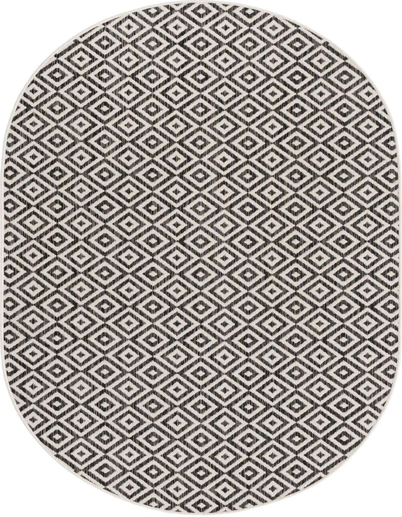 An oval 5'3" x 8'0" black and white Bohemian trellis rug with a textured flatweave.