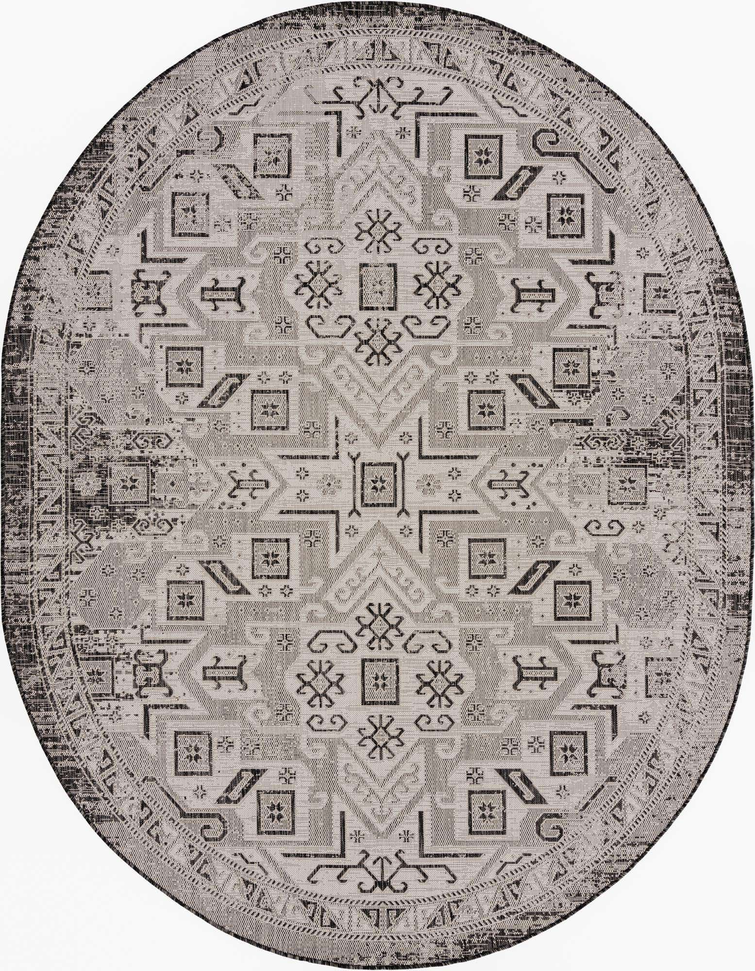 An oval 7'10" x 10'0" black and gray Southwestern rug with a distressed tribal pattern, suitable for indoor or outdoor use.