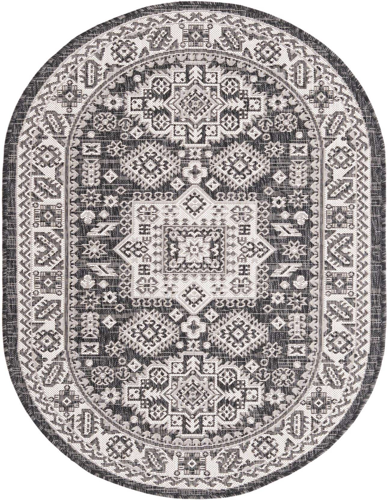 A 3' 0 x 5' 3 oval black and white Southwestern rug from the Outdoor Aztec collection, featuring a tribal geometric pattern.