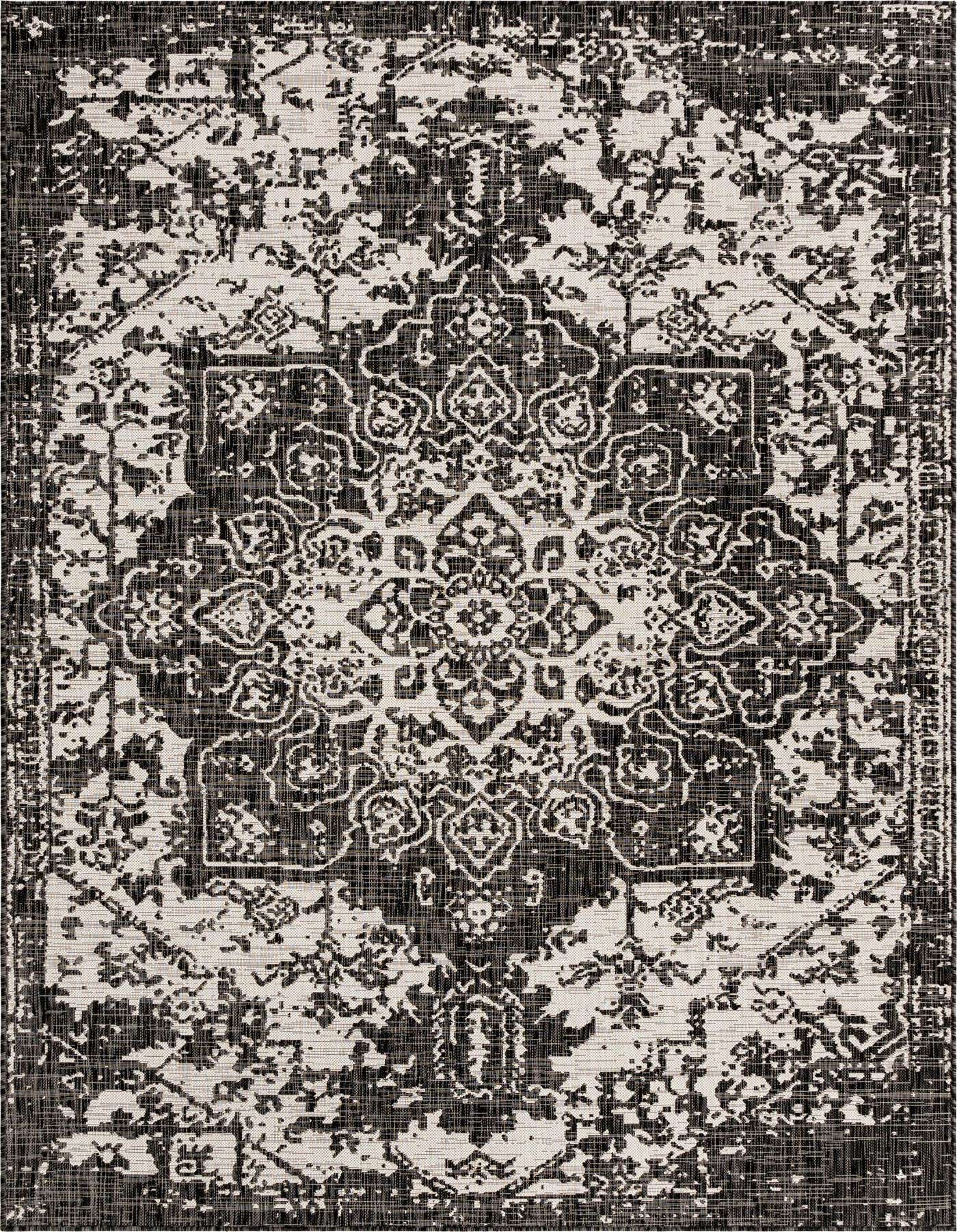 A 7x10 rectangular black and off-white Mediterranean medallion rug with a distressed, vintage look, suitable for indoor or outdoor use.