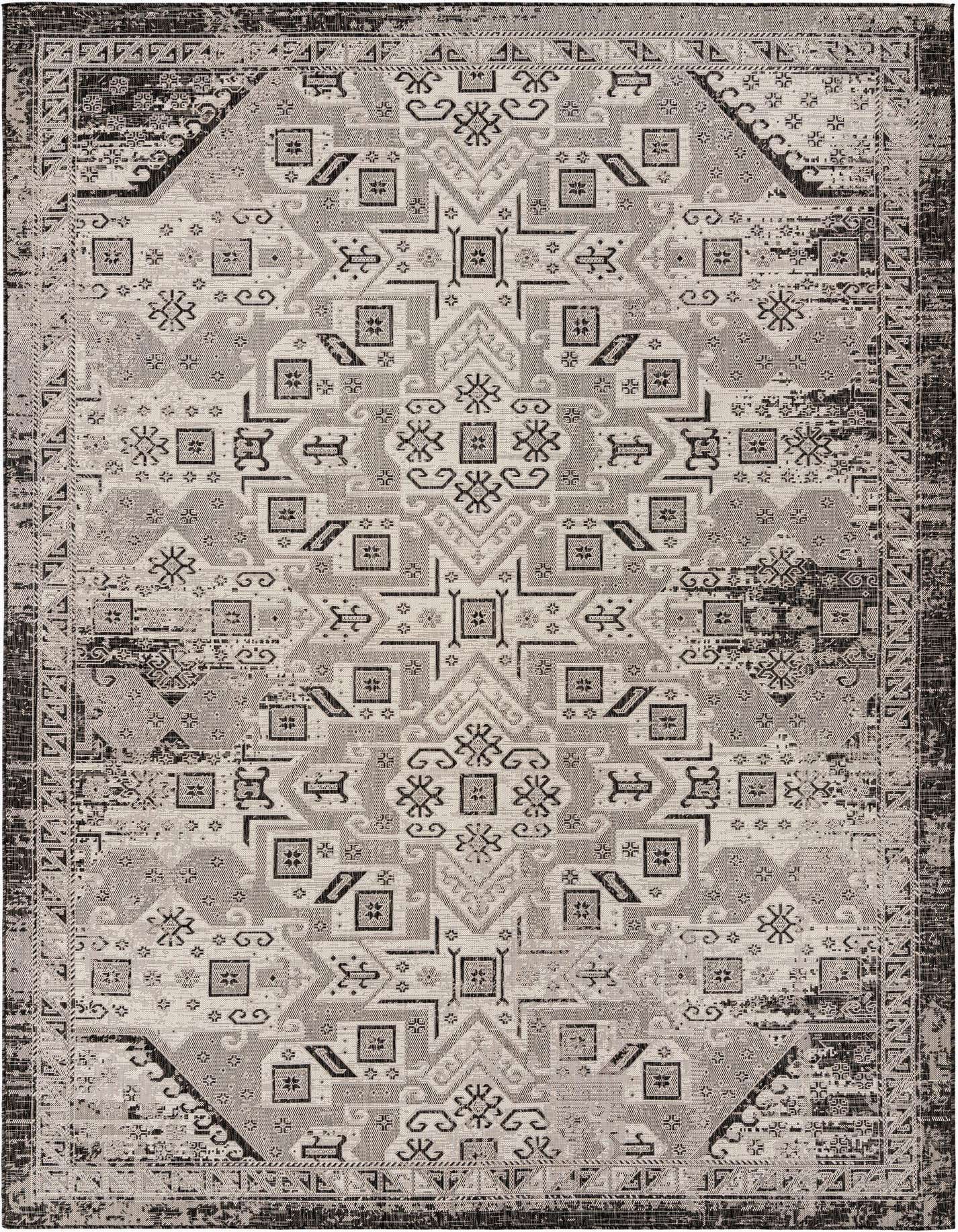 A 10x14 rectangular Rugs.com Outdoor Aztec rug featuring a distressed black and gray Southwestern tribal pattern, suitable for a patio.
