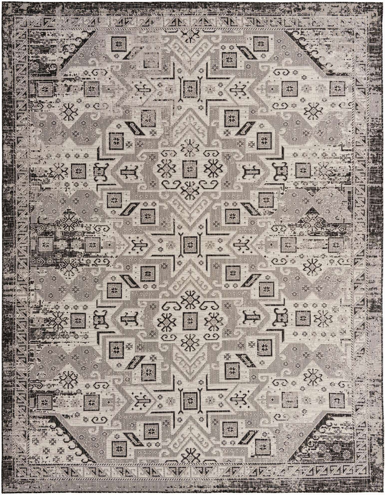 A 10x13 rectangular black and gray Southwestern rug with a distressed tribal pattern, suitable for indoor or outdoor use.
