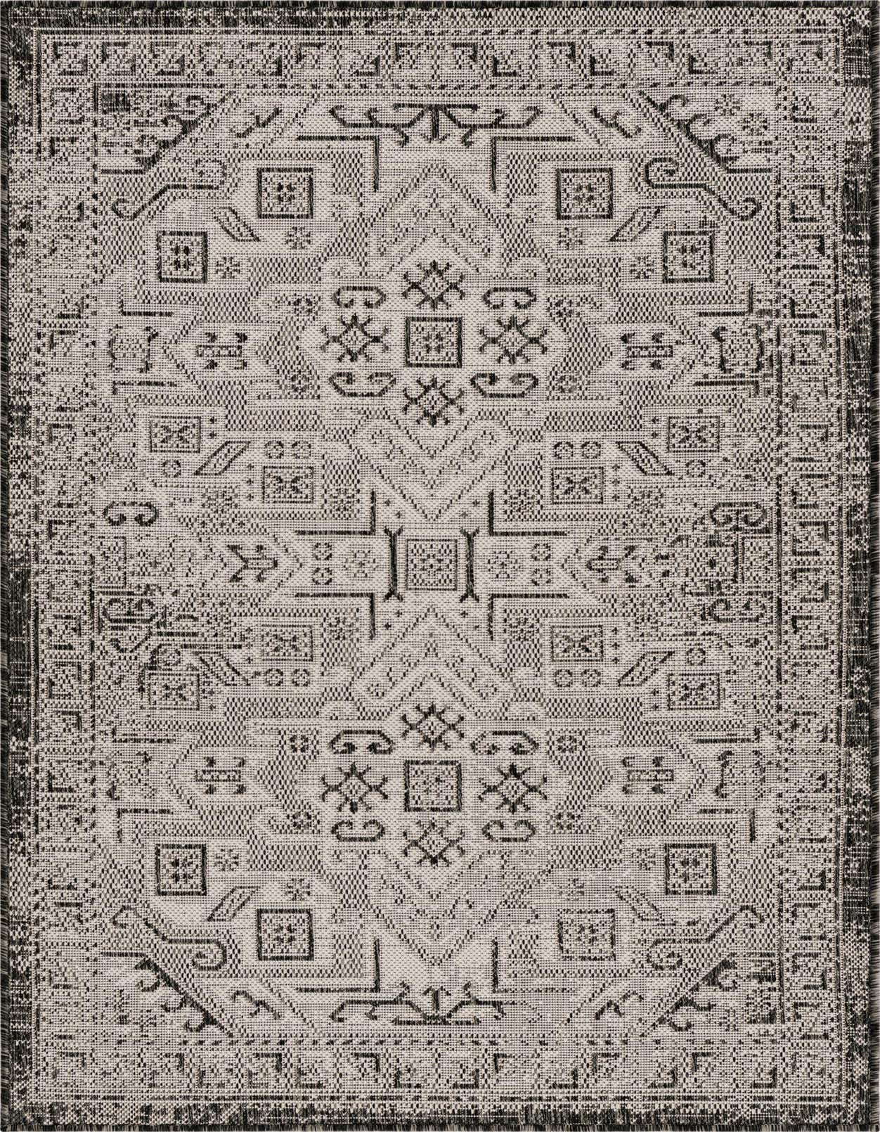 A 3x5 rectangular Rugs.com Outdoor Aztec rug featuring a distressed black and gray Southwestern tribal pattern.
