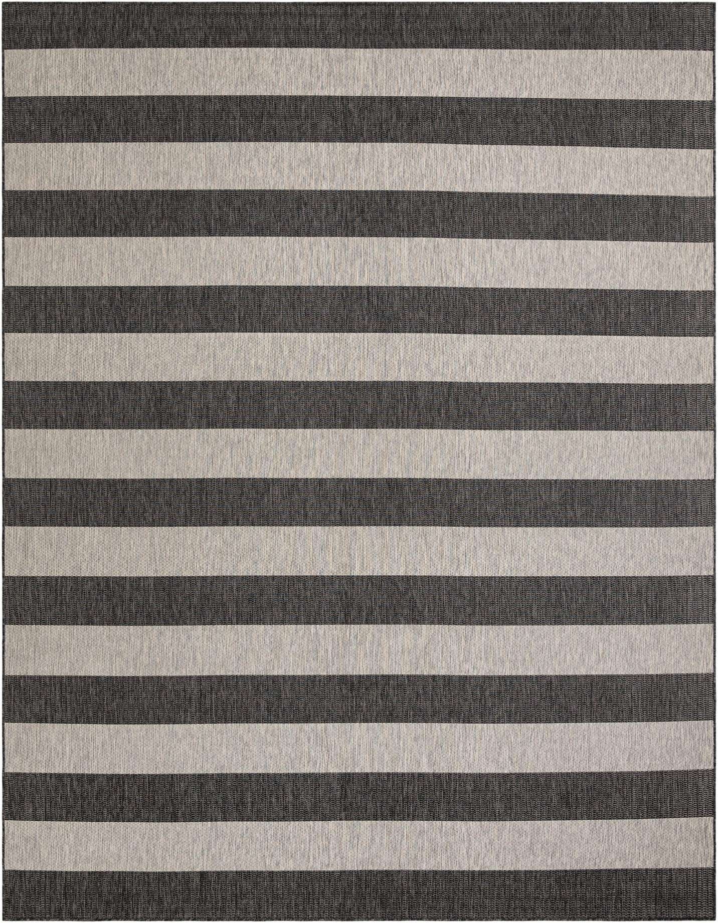 A 10x14 rectangular Rugs.com Outdoor Ribbon rug featuring wide horizontal stripes in black and light gray, suitable for a patio.