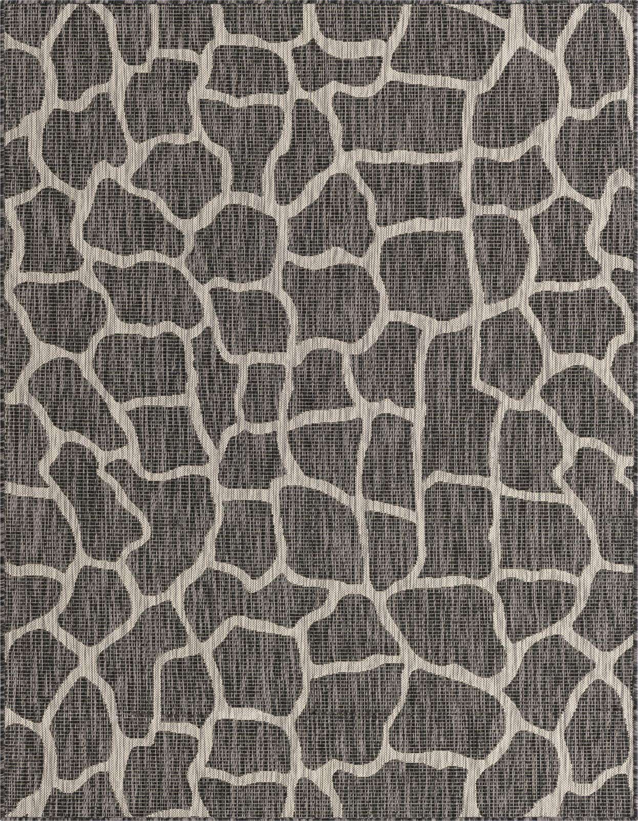 A 5x8 rectangular black and gray outdoor rug with an abstract, organic giraffe-like pattern, suitable for a modern patio.