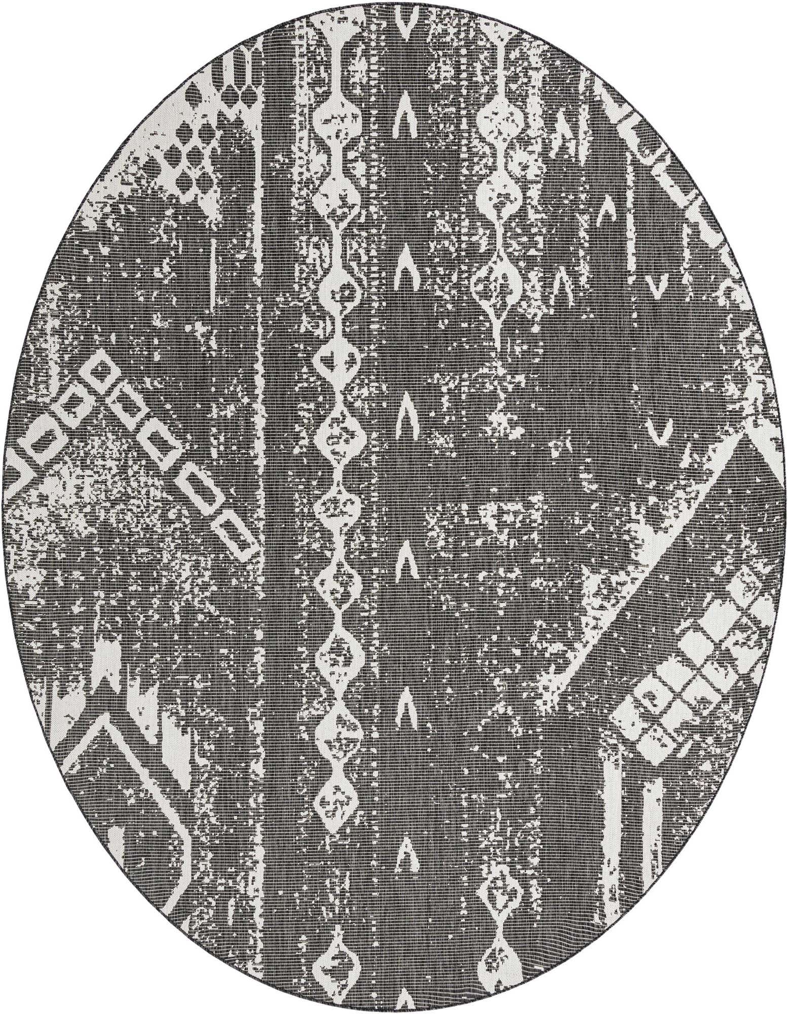 A large round black and white modern outdoor rug with a distressed geometric pattern, ideal for a patio.