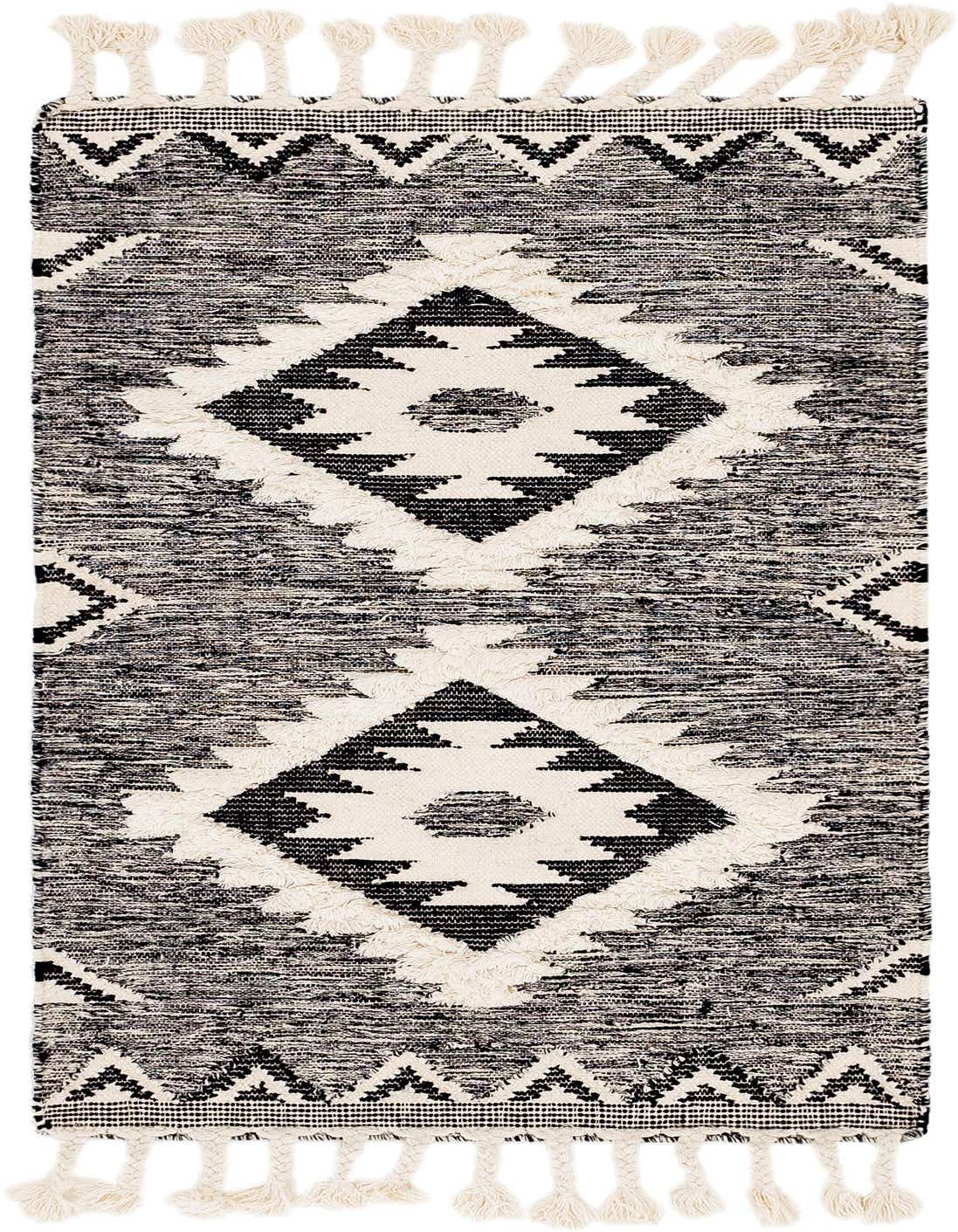 A 3x5 rectangular black and white tribal wool rug with a shag pile and decorative tassels.