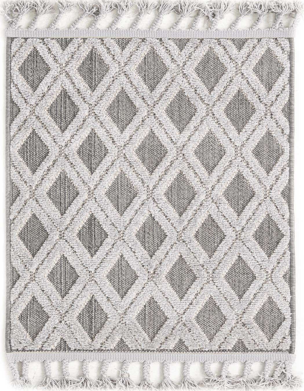 A 2x3 rectangular Arlo rug featuring a modern geometric diamond pattern in varying shades of black and gray, with decorative tassels along the short edges.