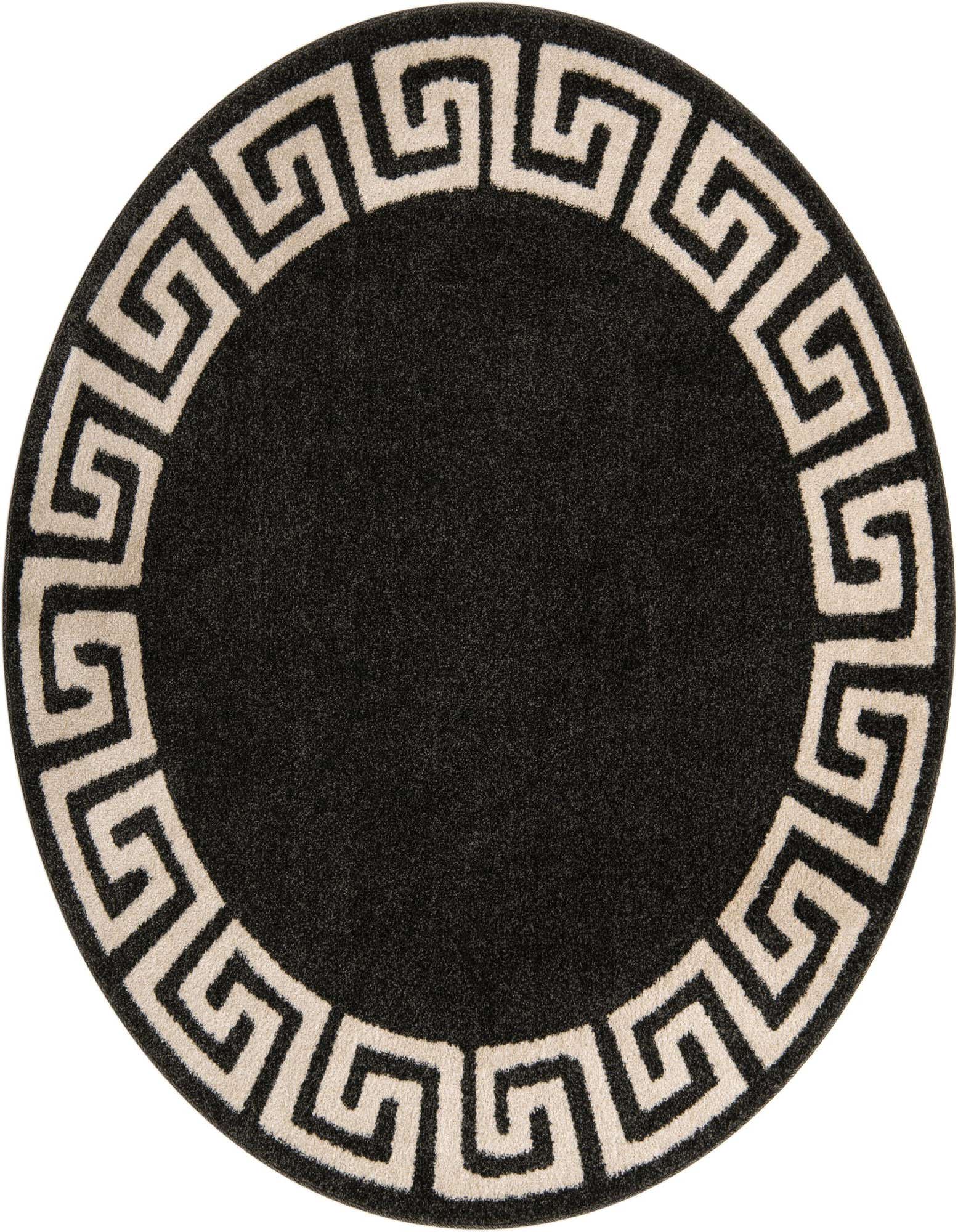 A round black area rug with a cream-colored Greek key border pattern, suitable for a modern living room.
