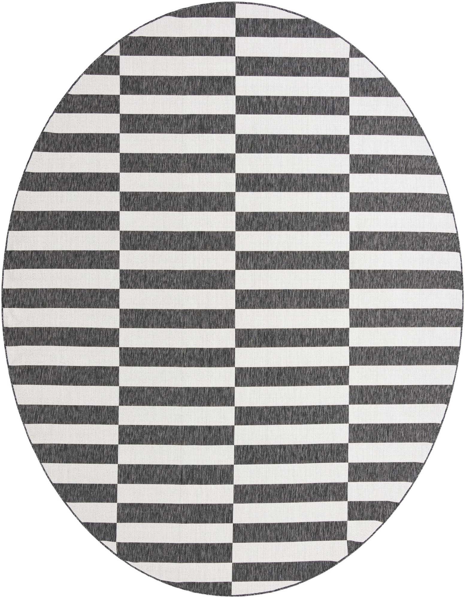 A large round black and white striped flatweave rug with a modern geometric pattern, suitable for indoor or outdoor spaces.