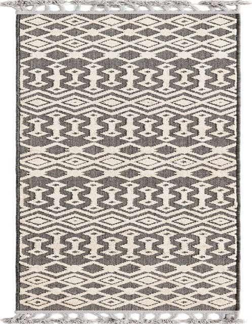 A black and cream tribal runner rug with a high/low textured pile and tassel ends, perfect for a hallway.