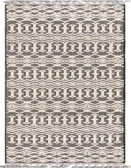 A 12 ft Arlo runner rug featuring a tribal geometric pattern in black and off-white with tassels.