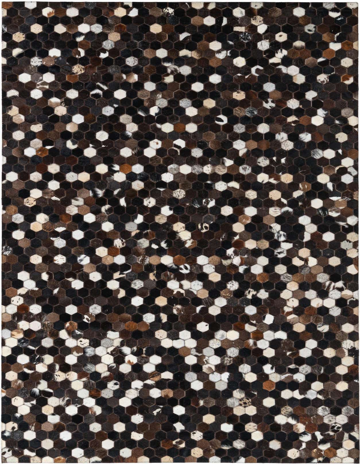 A rectangular 5x8 modern area rug made from hexagonal cowhide and leather patches in various shades of brown, tan, black, and white.