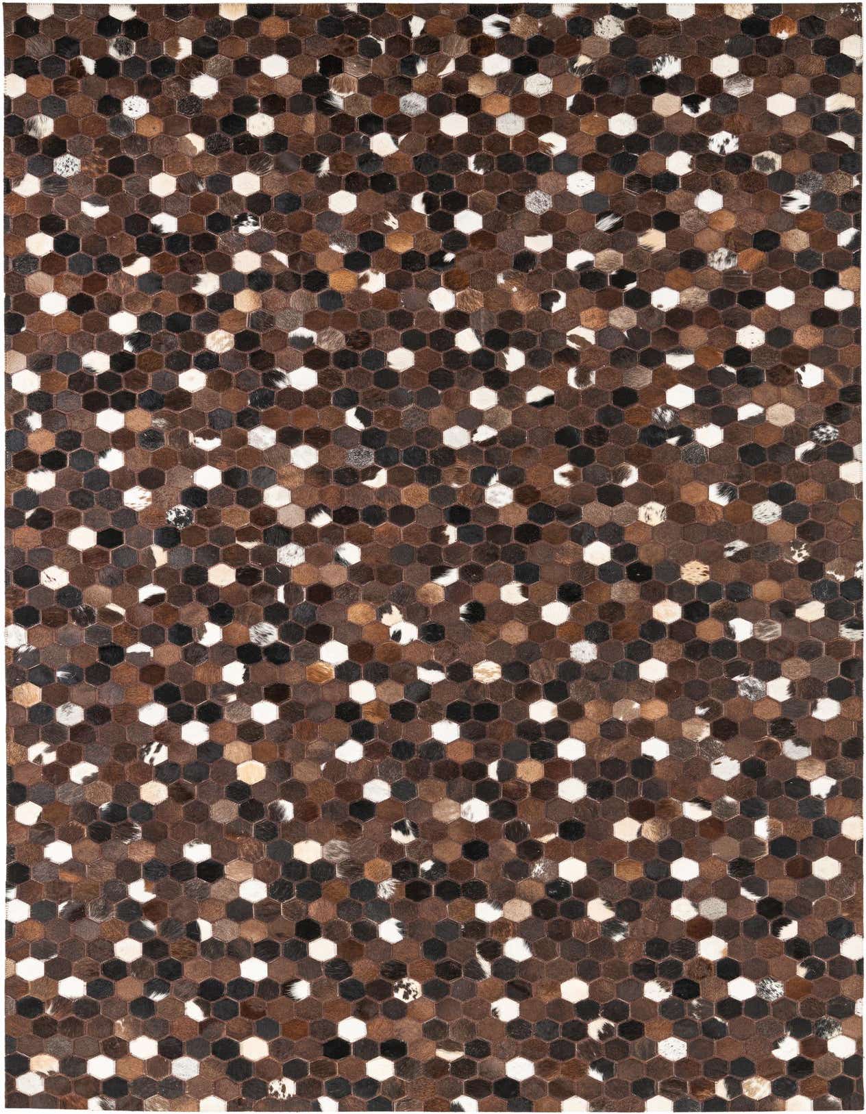 A rectangular 5x8 modern rug made from hexagonal cowhide and leather patches in various shades of brown, tan, black, and white.