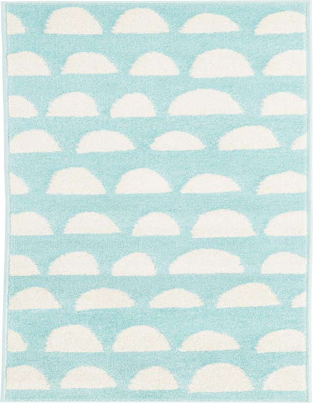 A 6 ft runner rug with a playful pattern of white cloud-like shapes on a clear blue background, perfect for a child's room or hallway.